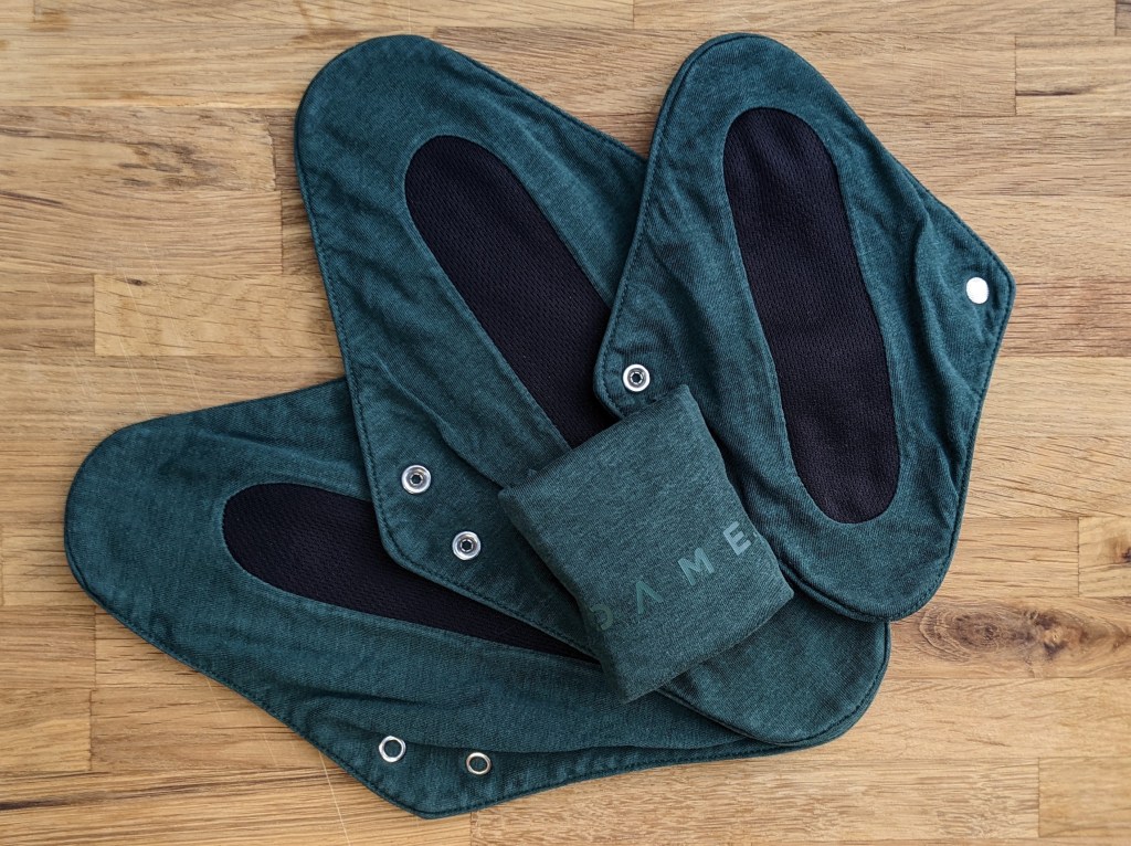 DAME period pads fanned out with one folded.