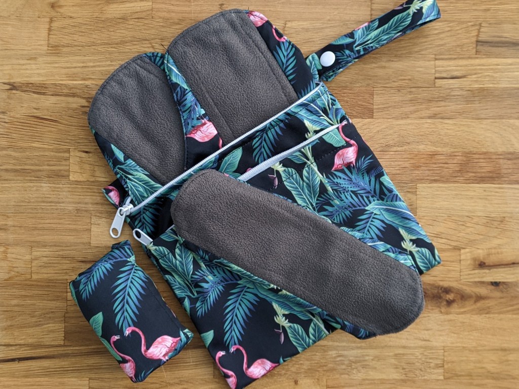 eco bravo period pads with wet bag and a folded pad.